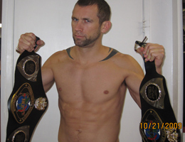 REPUBLIC Coach Dave Nielsen holding IKF California Muay Thai Championship Belt and IKF West Coast Muay Thai regional Championship Belt