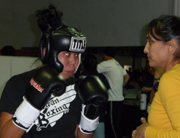 Kru Gina Reyes preparing and working the corner for Irene Estrada's first k-1 rules kickboxing match.